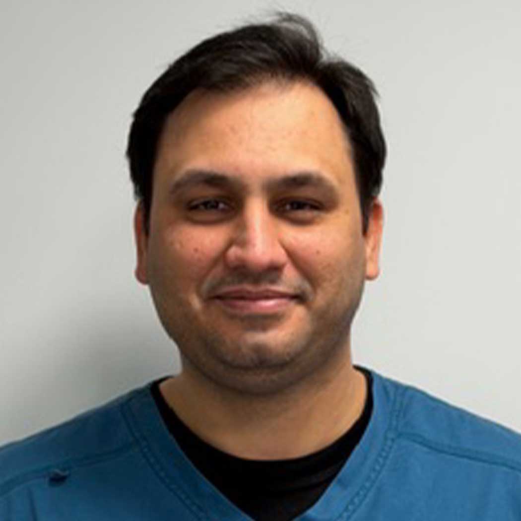 Man wearing a blue shirt against a plain background