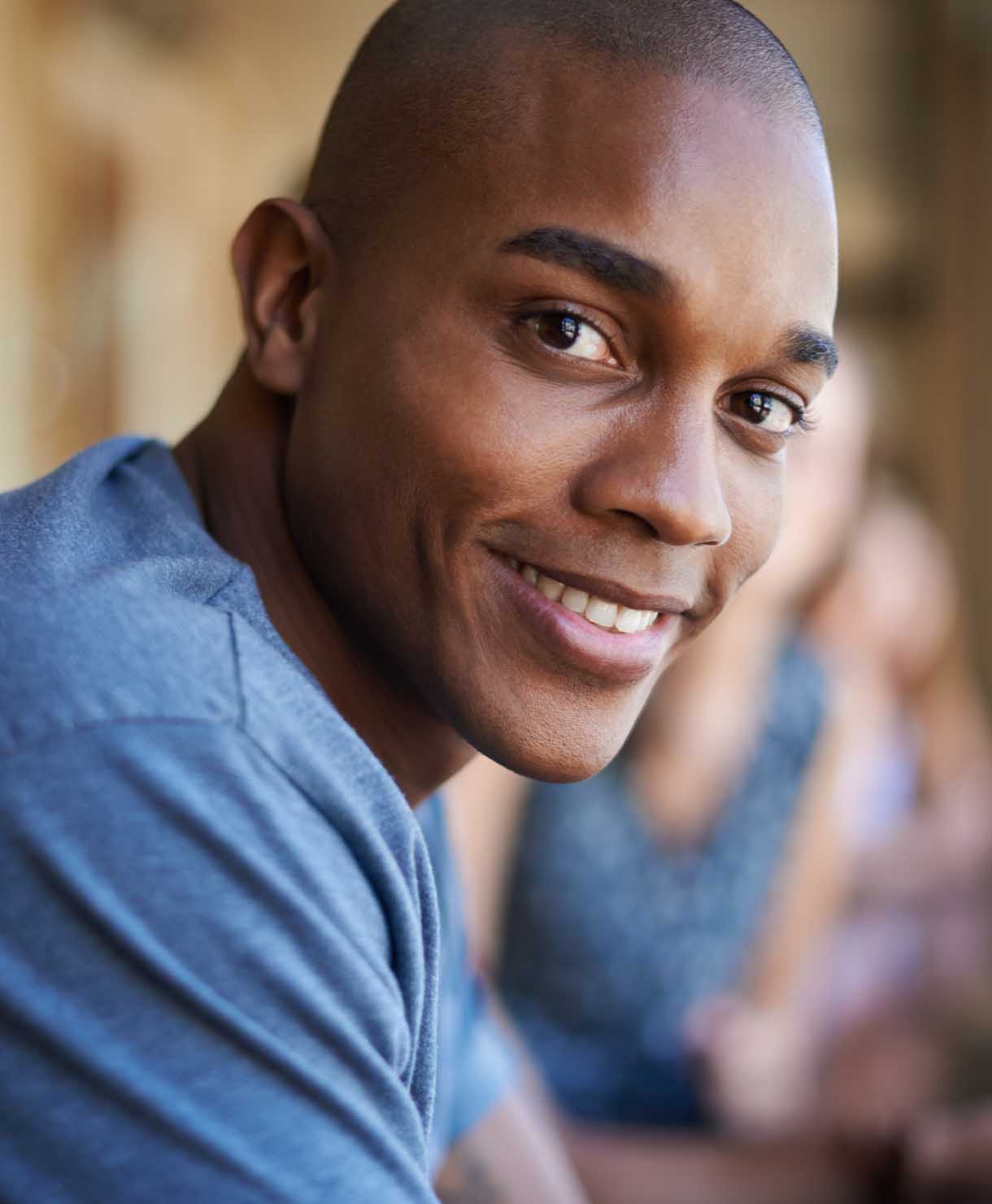 Man wearing a blue shirt with a blurred background