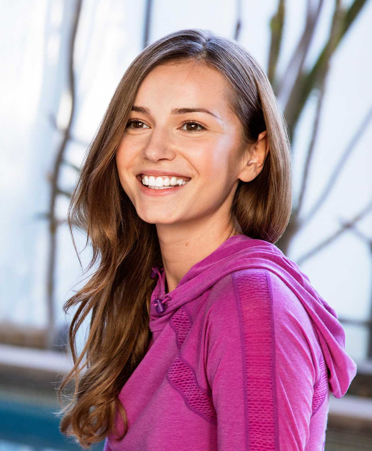 Woman wearing a pink hoodie with a blurred background