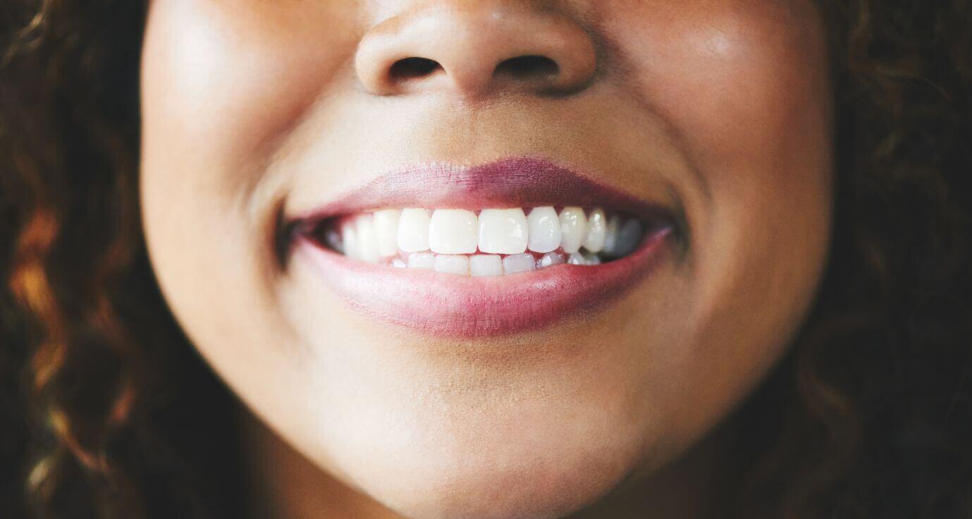 Close up of woman smiling and showing teeth